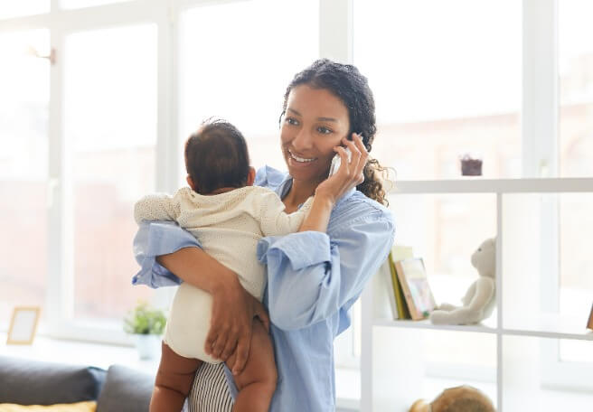 Woman On Phone Holding Baby (1)